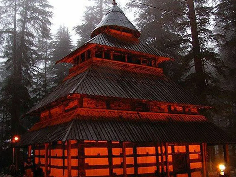 Illuminated pagoda style wooden architecture of Hadimba Temple at night in Manali