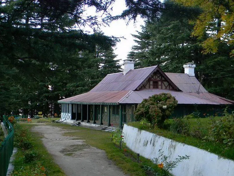 Colonial style forest rest house building nestled in dense pine woods at Kalatop Wildlife Sanctuary Dalhousie