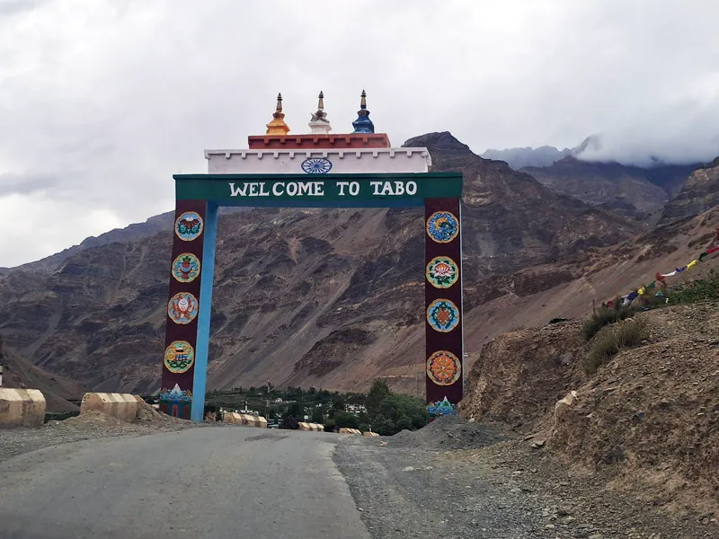 Welcome to Tabo ornamental gateway arch on mountain highway surrounded by arid Himalayan slopes
