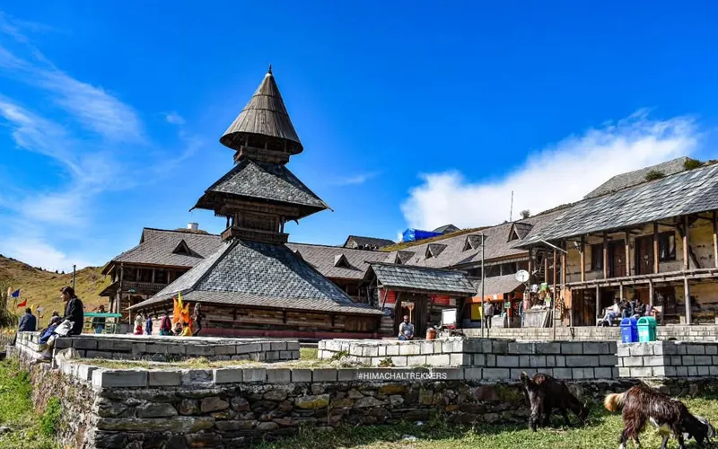 Historic multi-tiered wooden Prashar Rishi temple set against alpine hills near Prashar Lake